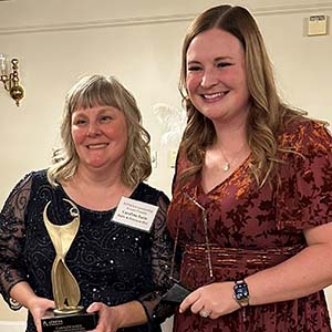 Caroline Earle, with trophy, and Sarah Gallant.