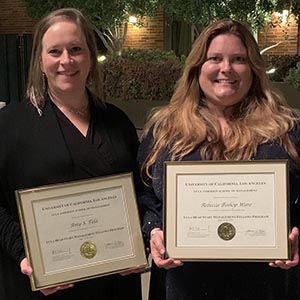 Amy Fela and Rebecca Bishop Ware show off graduation certificates.