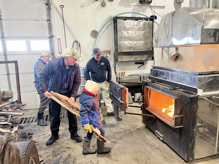 Photo: Governor joined the Solinsky family and Vermont Secretary of Agriculture Anson Tebbetts to tap a maple tree. Courtesy photo.
