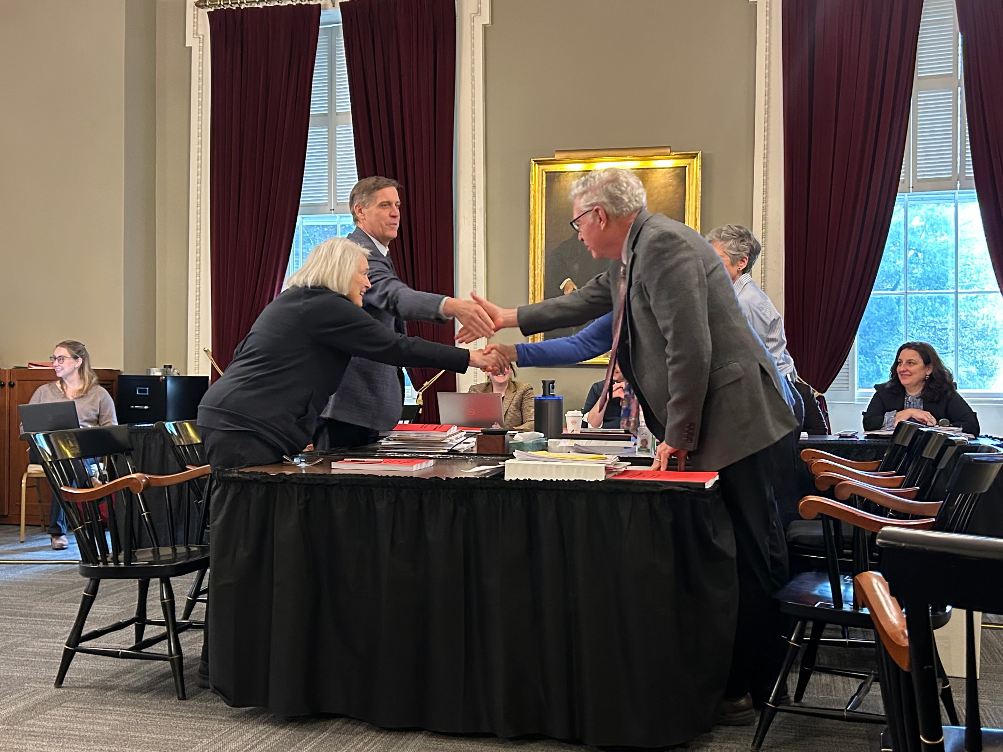 The Vermont FY26 Budget Conferees shake hands on their final draft on Friday. Photo Credit: Ashley Moore, Pro Tem's office. 