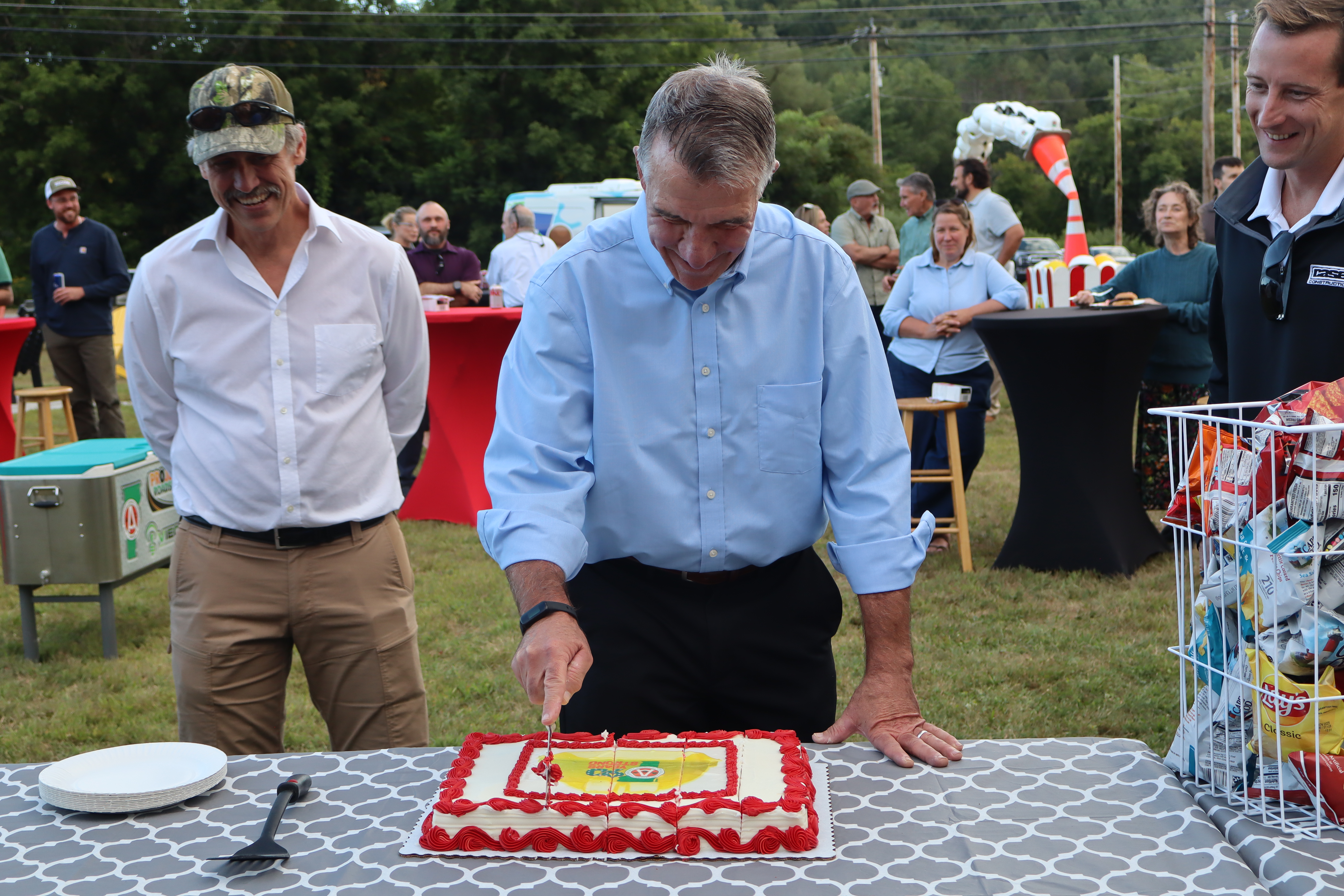 Governor Scott cuts the cake, with Lieutenant Governor Rodgers, left, and John Casella, Jr. Founder of Casella Construction and AGC-VT's current president.