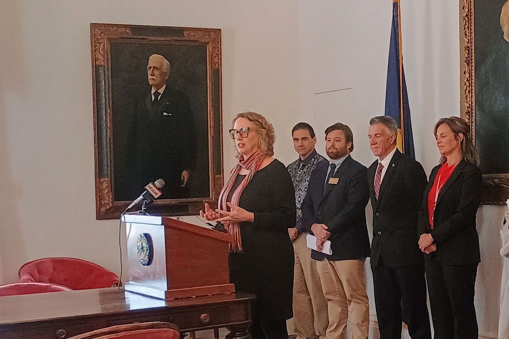 Angie Harbin, executive director of Downstreet, discusses the award at Governor Scott's press conference on December 10. 2025.