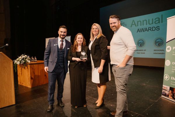 Brandy Lesser and Chris Macksey of Haberdasher Wine & Provisions receive the New Member of the Year award from the Chamber