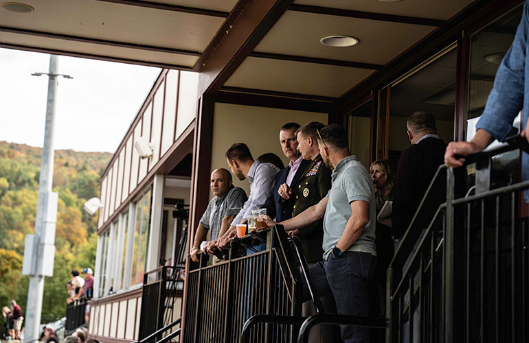 Photo: BG McCollough (uniform center) and Dr Travis Morris (far left) engage in conversations. Courtesy photo.