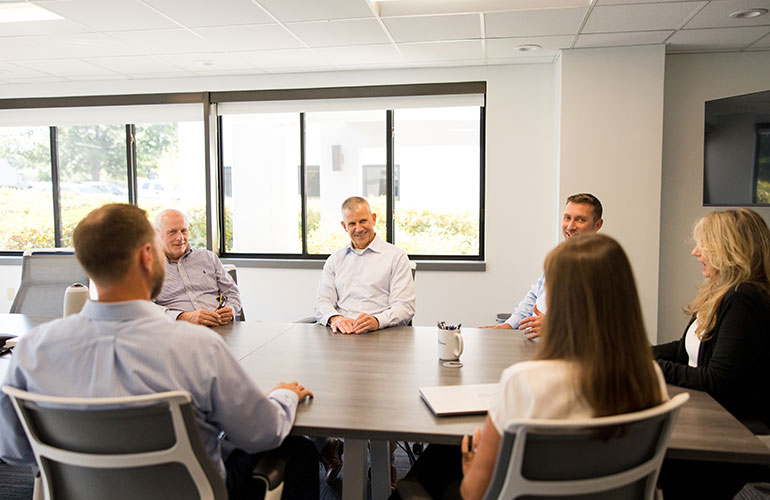 Photo: Bank of Burlington CEO Geoffrey Hesslink leads a meeting of bank employees. Courtesy photo.