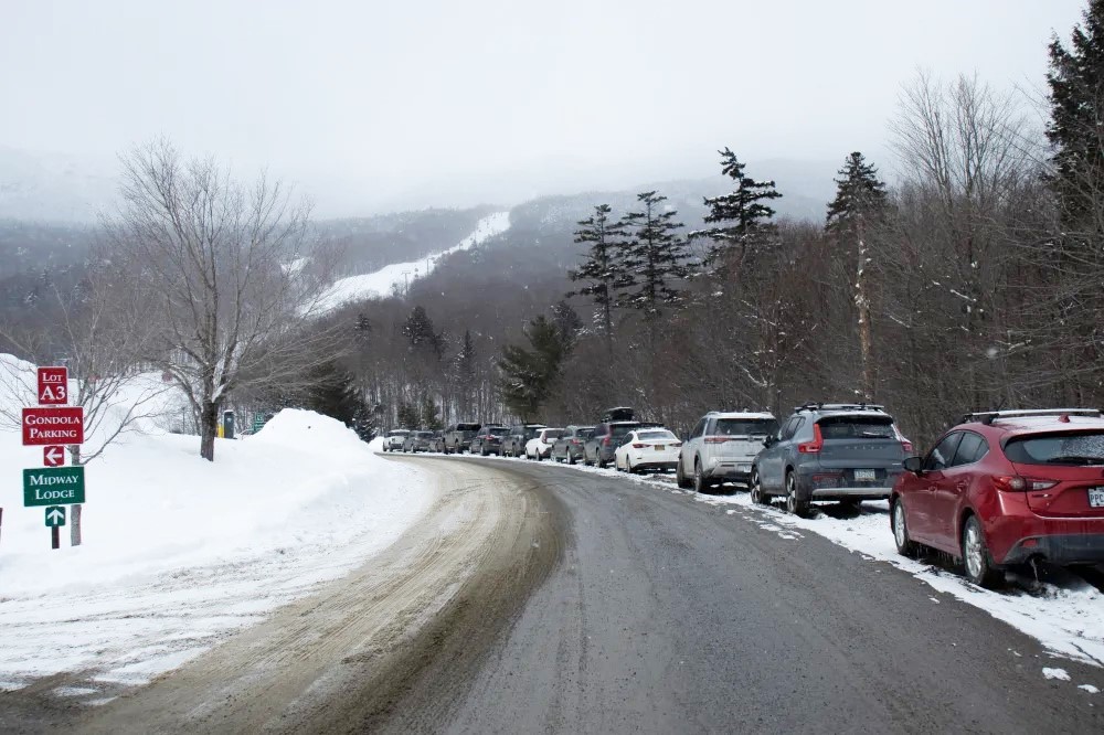 Cars parked along the street due to full lots at Stowe Mountain Resort.