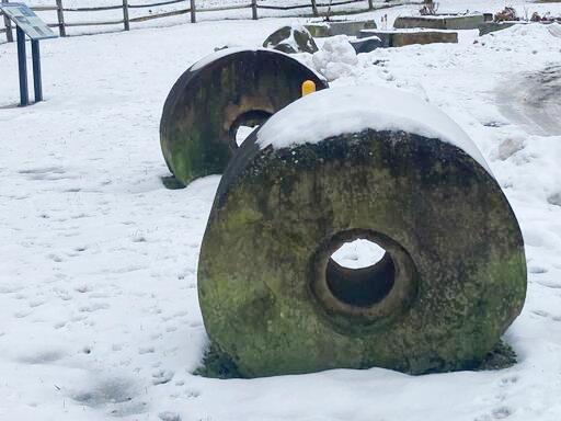 Two large pulp milling stones, salvaged from the Connecticut River