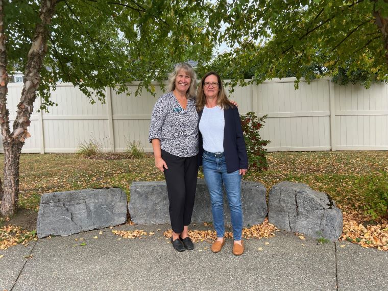 Cathedral Square CEO Kim Fitzgerald and Miller family spokesperson Stephanie Miller Taylor in the garden at Memory Care at Allen Brook.
