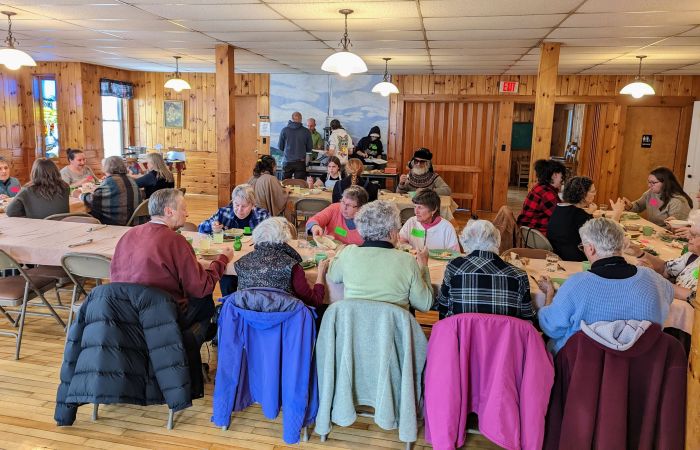 Photos:   Students and community members share a meal made by the Recipe for Human Connection class in November, 2022. Photo provided by Center for an Agricultural Economy