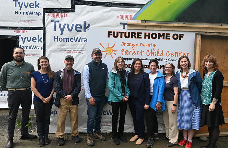 Photo: Lead organizers who attended and spoke at Tuesday’s groundbreaking in Randolph stand under the newly unveiled sign at the Woodlands Campus. Pictured from left to right: James Paradissis, Fauna Hurley, Rep. Larry Satcowitz, Chris Saunders, Joyce Judy, Aly Richards, Erika Hoffman-Kiess, Erin Roche, Carolyn Wesley, Lindsey Trombley. Courtesy photos.