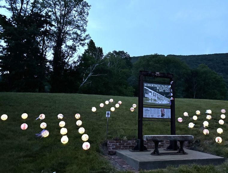Dozens of lanterns, lit at dusk, were decorated by locals with paper salvaged from the mill.