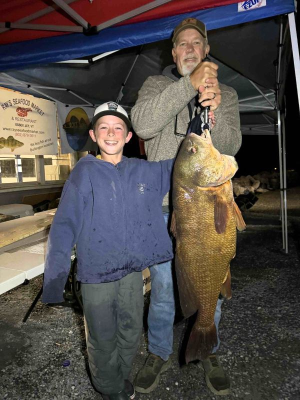 Grayson Carey, shown here with his grandfather Jeff Morse, caught this 28.5-pound Freshwater Drum while fishing the 2025 LCI Father’s Day Derby last June.&nbsp;