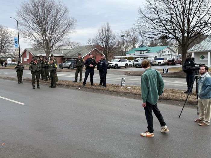 Vermont State Police and South Burlington PD officers congregate on the Dorset Street median.