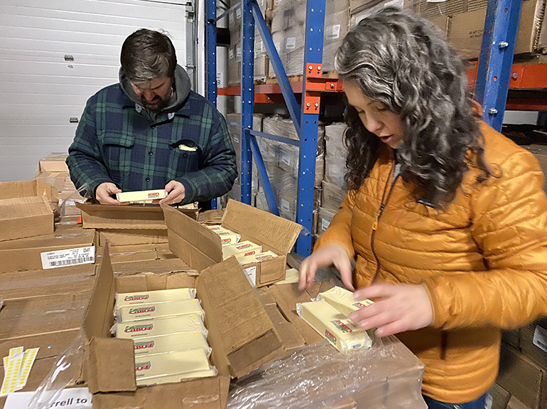 Photo: Cabot team members evaluate packaged cheese bars after a 300-mile road test to ensure the sustainable packaging meets our supply chain standards. Cabot photo.