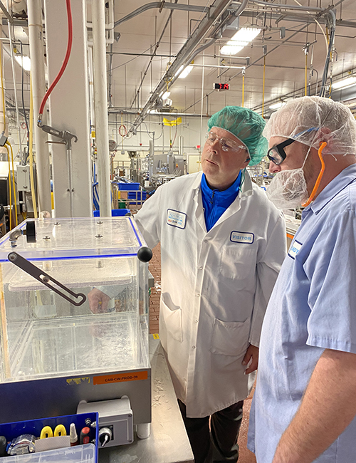 Photo: Jim Jankowski, Technical Service Manager from TC Transcontinental Packaging, and Randy Welch, Cut & Wrap Line Leader, conduct a leak detection test to ensure all packages were properly sealed. Cabot photo.