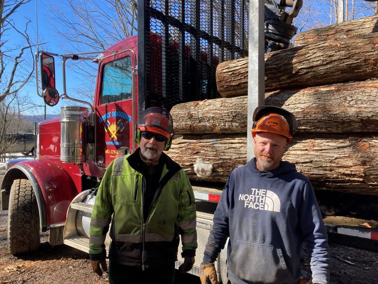 Jed Lipsky and Ivan Ainsworth take a break on the landing after loading a log truck with soft maple sawlogs.
