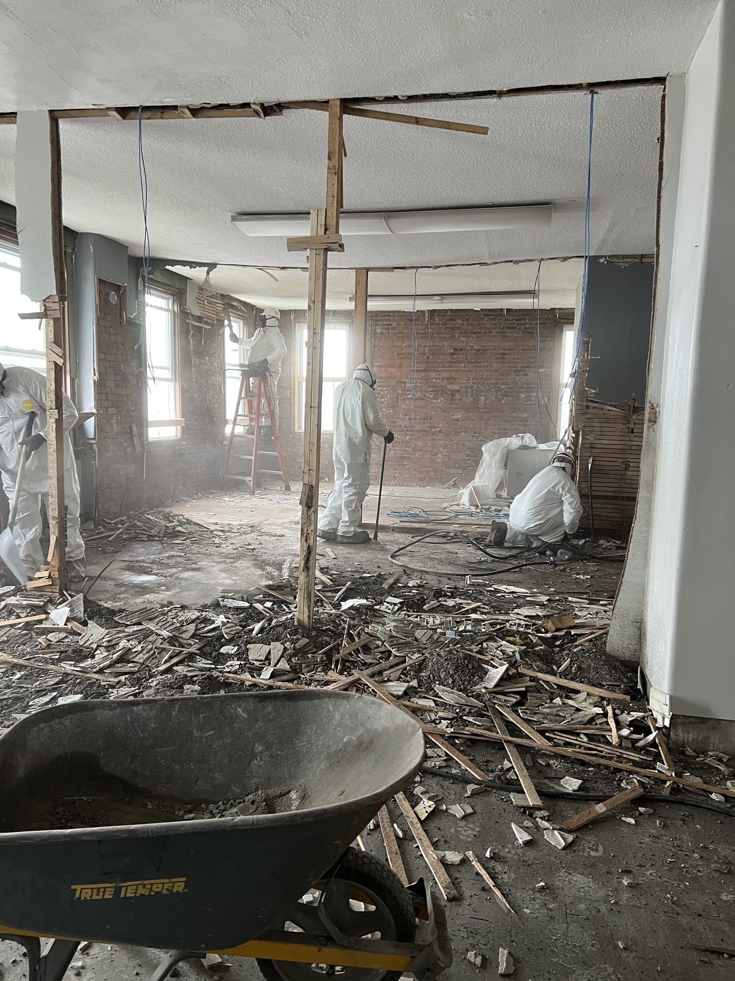 Workers strip the old interior walls and systems from 560 Railroad Street.