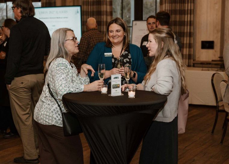 Pictured: Members of the Chamber enjoying a complimentary sparkling beverage to kick the night off