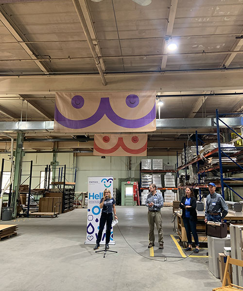Mamava co-founder Sascha Mayer, left, speaks at a 2022 open house at the company’s Springfield production facility as Vice President of Manufacturing Joe Wright, co-founder Christine Dodson and Executive Vice President of Operations Mark Wiggins look on.   Photos Courtesy of Mamava.