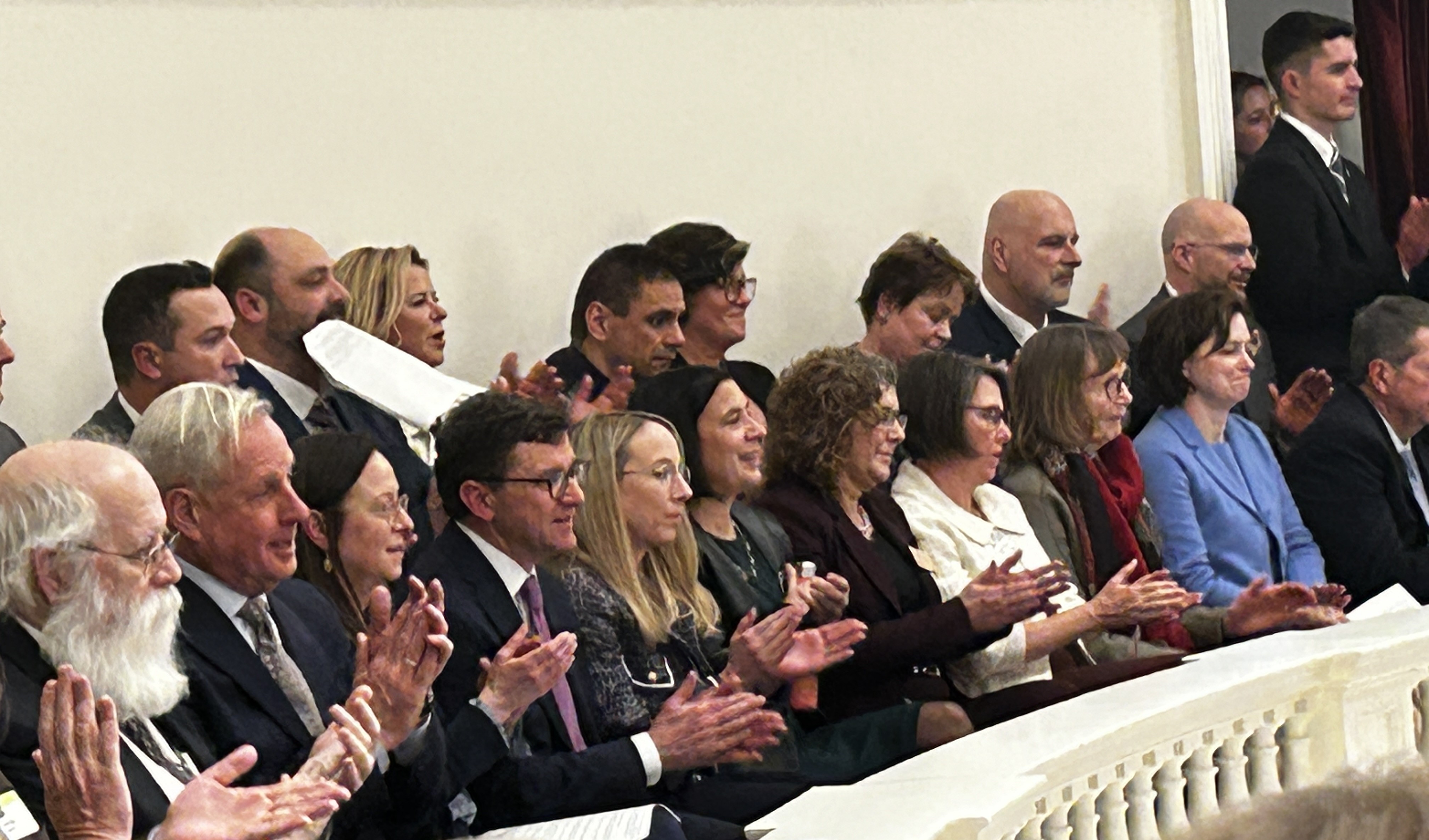 Friends and members of the Administration applaud Governor Scott from the balcony.
