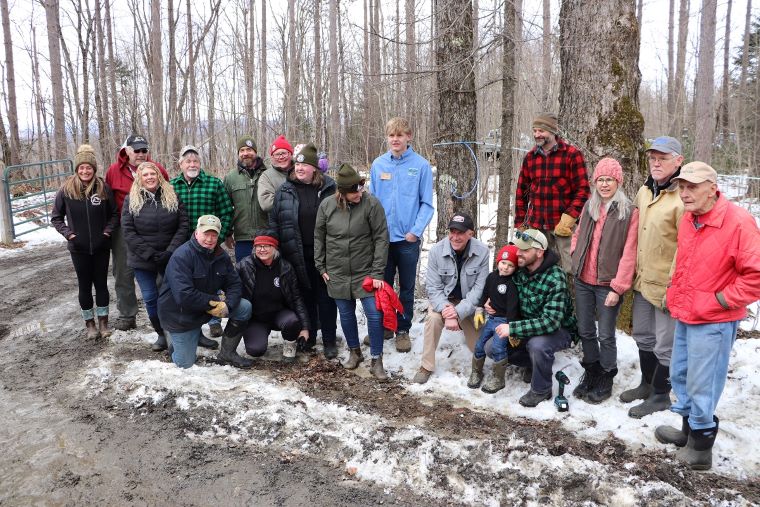 Vermont Governor Phil Scott tapped a maple tree at Buck Family Maple in Washington Monday.