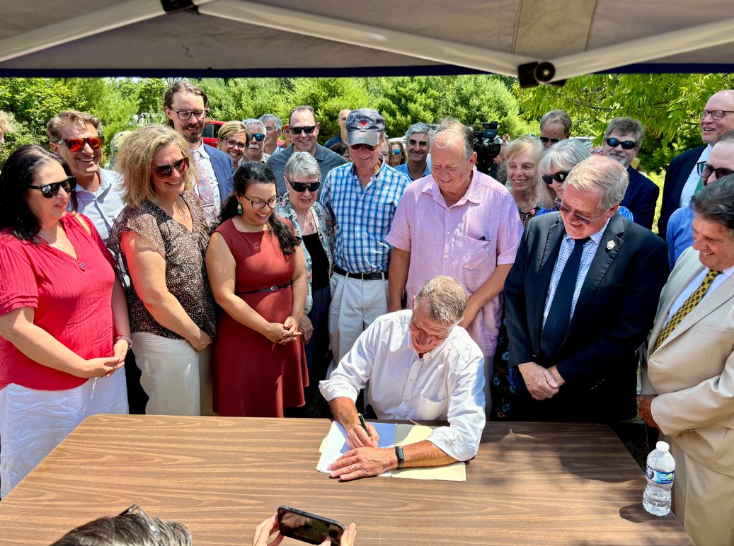 Governor Phil Scott, members of the administration, legislators, community partners, and others celebrated the passage of S.127, An act relating to housing and housing development (Act 69), in Fair Haven on Wednesday.