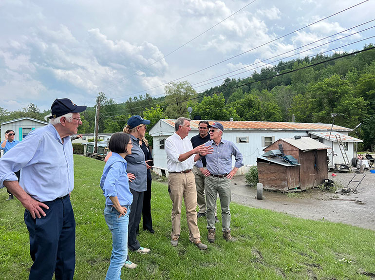 Deanne Criswell, Administrator of FEMA (center in blue cap), visited a flooding site in Barre, Vermont, in July 2023, with Bernie Sanders, Becca Balint, Phil Scott and PEter Welch.