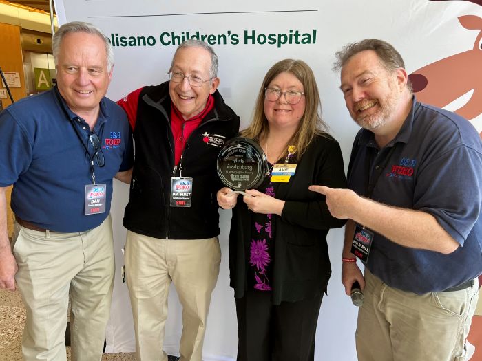 Amie Vradenburg (second from right) receive the inaugural Victory for Kids Award from Dan Dubbonnet, general manager of WOKO