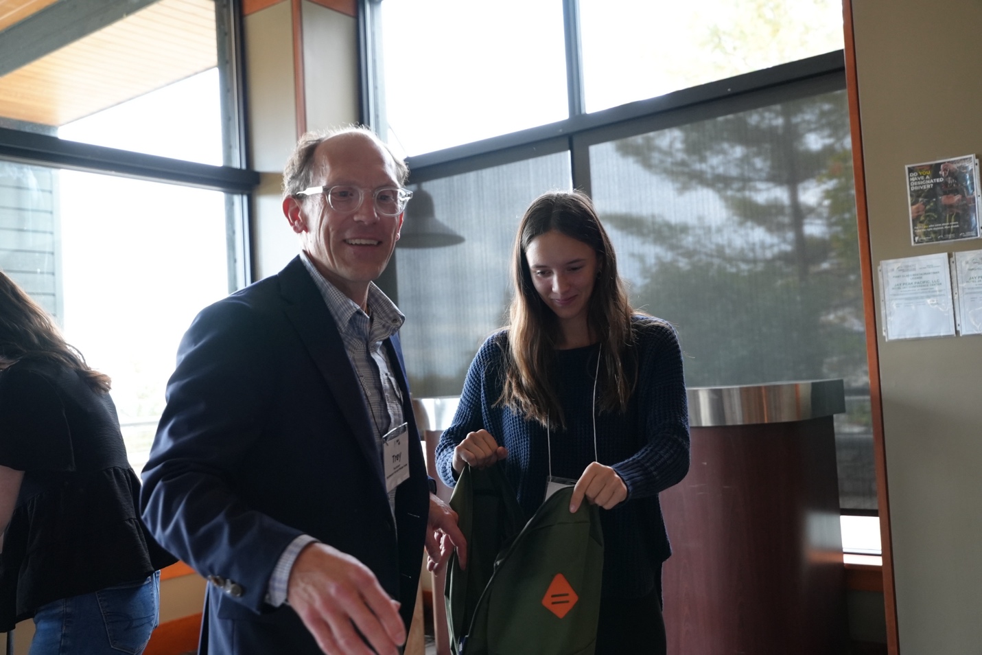 VAHHS board member Trey Dobson, chief medical officer for Southwestern Vermont Medical Center, works with NCUHS senior Kaitlin Niles to fill a backpack with shelf-stable food for students experiencing food insecurity.