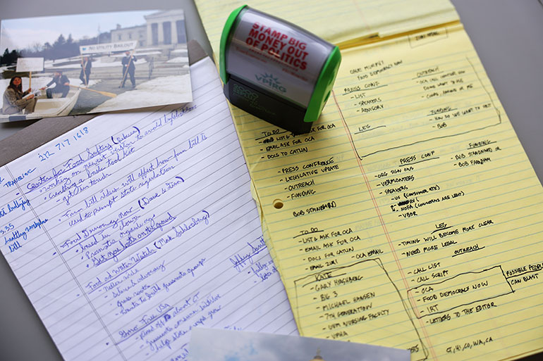 Photo: Hand-written meeting notes, protest photos and an VPIRG self-inking stamp that says “Stamp Big Money Out of Policitcs” are among the objects in the VPIRG collection given to the UVM Silver Special Collections Library. Courtesy photos.