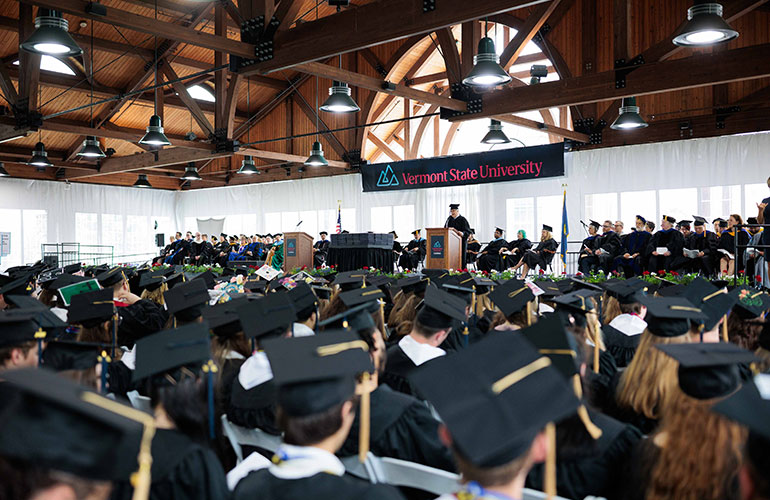 Photo: John Casella delivers the keynote address at VTSU Castleton commencement May 17. Courtesy photo.