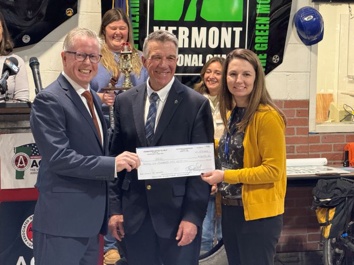 Tom Donahue, left, CEO of BROC Community Action in Rutland, accepts a check for $36,000.