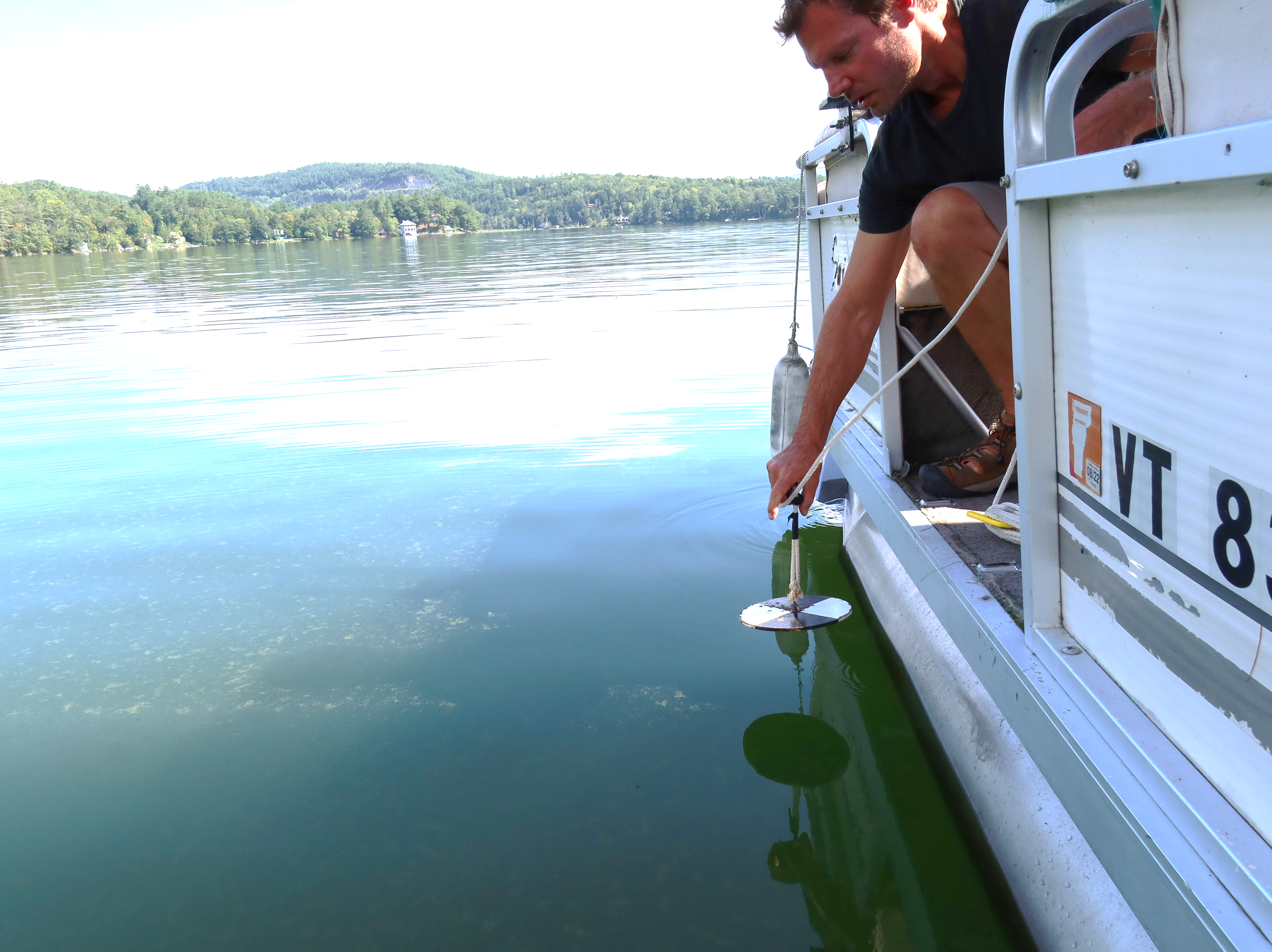 Photo: Lay Monitoring Program training to measure water clarity using a Secchi disk and report cyanobacteria observations. Courtesy photo.