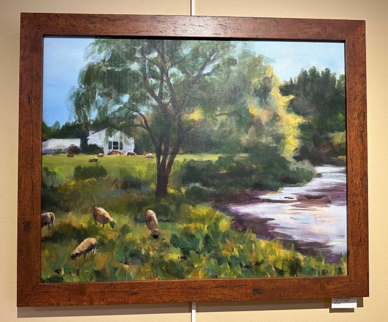 Jennifer Dembinski, whose paintings hang at Gifford, is a resident of Woodstock. Her pieces include “Muskrat Meal,” an acrylic; “Emergence,” a watercolor showcasing spring flowers breaking through dead leaves; and “Pastoral Scene, Clay Hill Road,” an acrylic with sheep dotting a riverside scene.