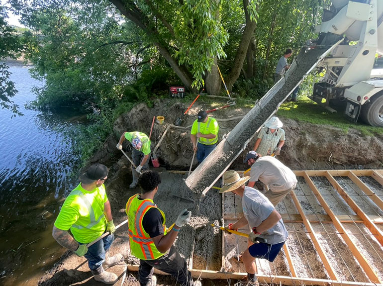 Photos: The Northern Forest Canoe Trail's roving stewardship crew and workers with the Swanton Public Works Department spread concrete into wooden forms for a new boat ramp. Courtesy photos.