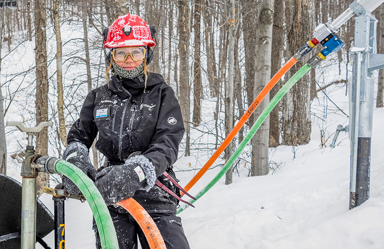 Photo: Resort & Hospitality Management student working a snowmaking machine. Courtesy photo.