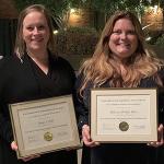 Amy Fela and Rebecca Bishop Ware show off graduation certificates.